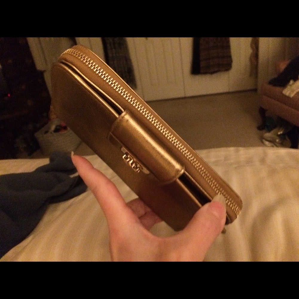 Salvatore Ferragamo gold leather wallet.
